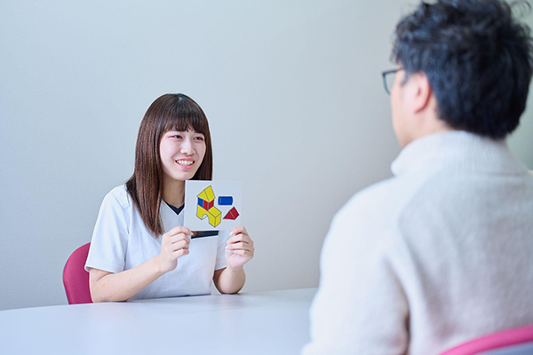 言語聴覚士を目指す和泉大学の学生が実習を行っている様子。積み木の絵が描かれた絵カードを使用した語彙獲得訓練。